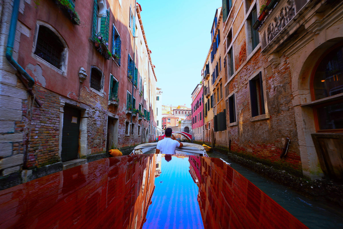 Shining Taxi Navigating Venice Canal